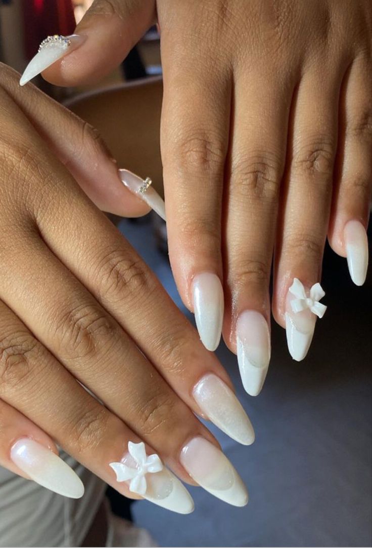 Sophisticated Almond-Shaped Ombre Nails with Whimsical Bows and Pearls.