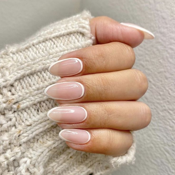 Timeless Elegant French Tip Nails: Chic Almond Shape with Glossy Finish.