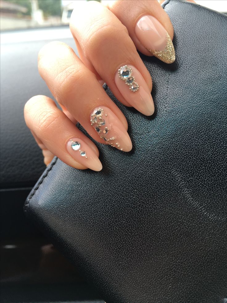 Glamorous Nude and Glittery Gold Nail Design with Rhinestones.