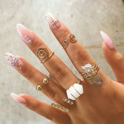 Bohemian-Chic Almond-Shaped Nails with Nude Polish and Sparkling Embellishments.