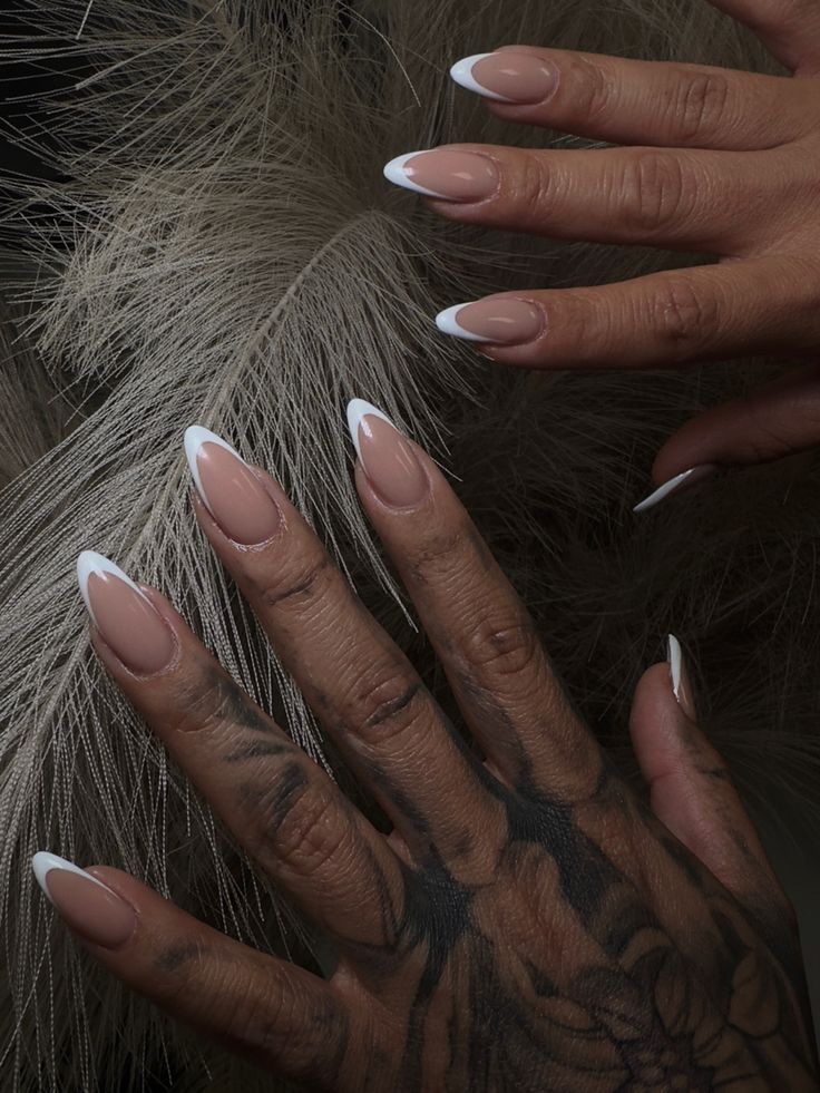 Sophisticated Almond-Shaped Nail Design with Nude, White, and Artistic Tattoo Accents.