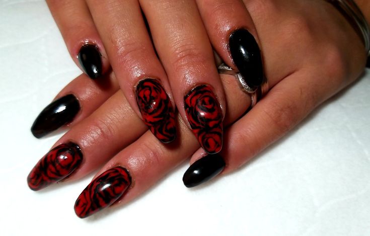 Sophisticated Nail Art: Bold Black Polish with Intricate Red Rose Patterns