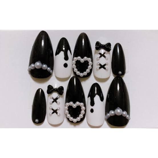 Sophisticated Chic: Glossy Black and White Nail Design with Playful Accents.