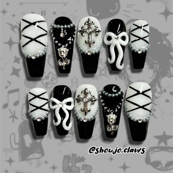 Chic Black and White Nail Design with Intricate Embellishments and Edgy Textures.