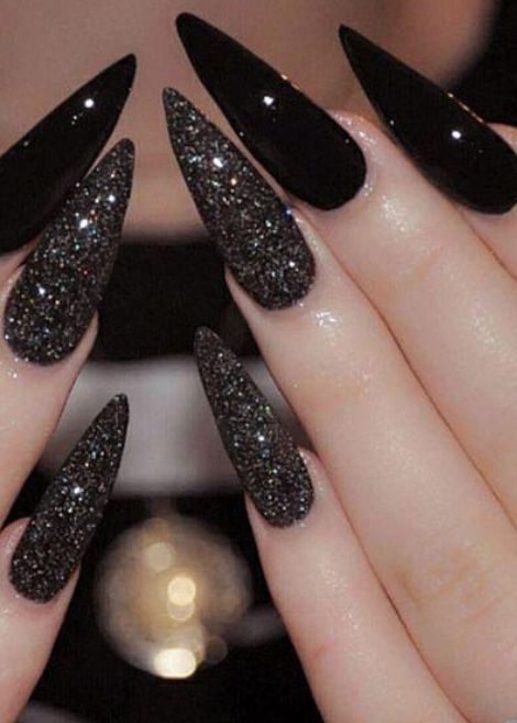 Edgy Elegance: Bold Elongated Black Nail Design with Glossy and Glittering Textures.