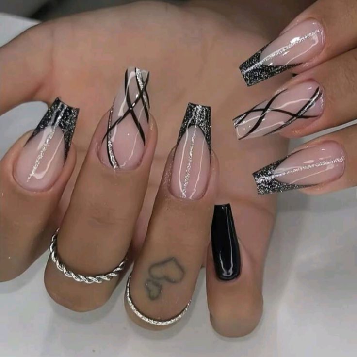 Chic Nude and Black Nail Design with Silver Glitter Accents and Intricate Lines