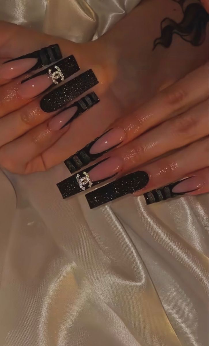 Elegant Long Acrylic and Gel Nail Design with Glossy Black Tips and Sparkling Accents