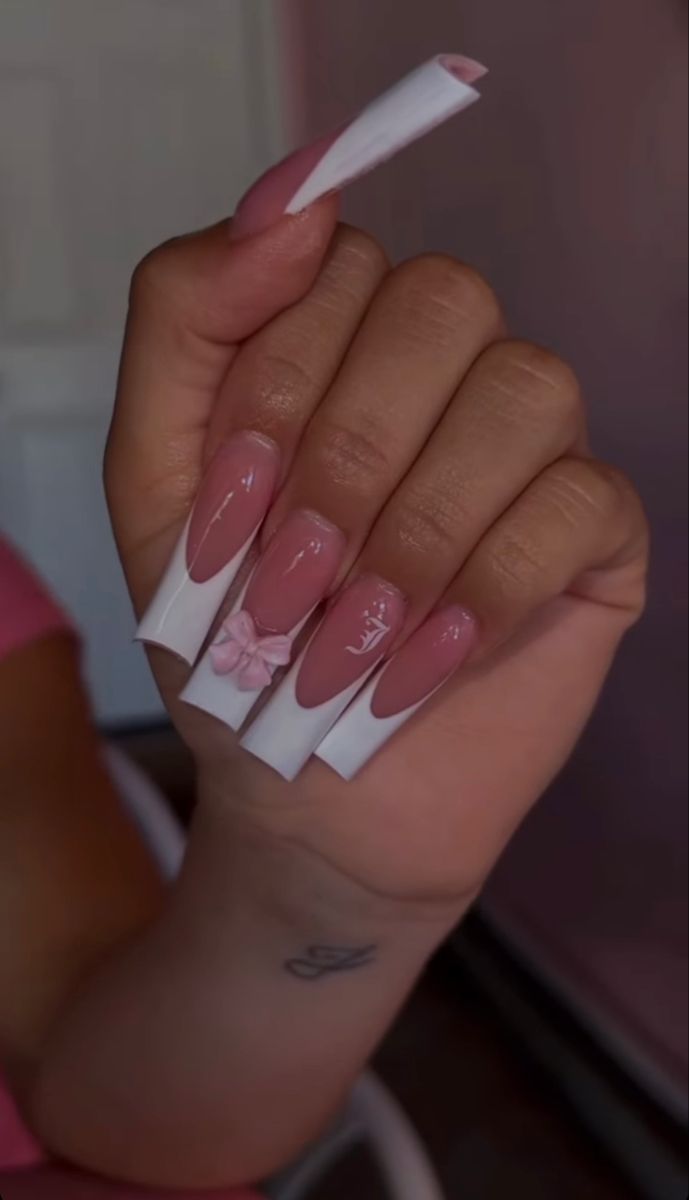 Sophisticated Soft Pink Almond Nail Design with Unique Accents and Charming Bow.