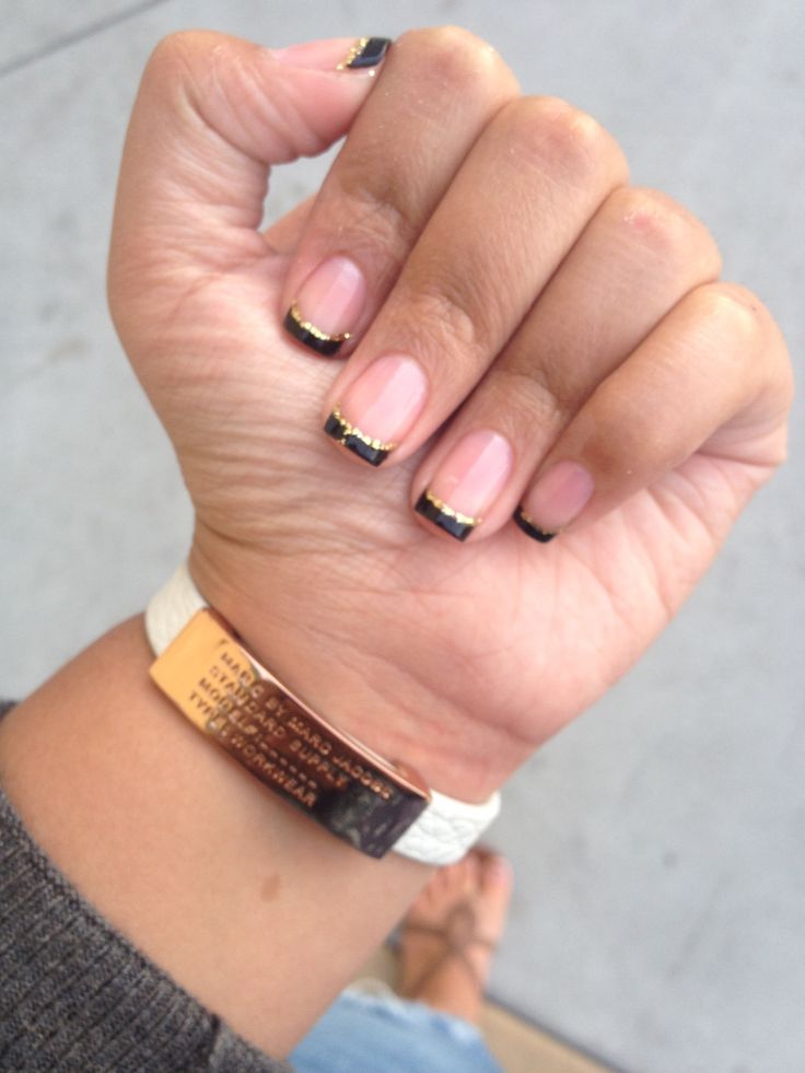 Elegant Minimalist Nail Design with Nude Base, Black Tips, and Gold Accents