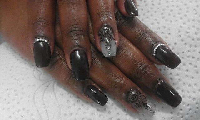 Chic Glossy Black Nail Design with Gradient and Elegant Silver Accents.