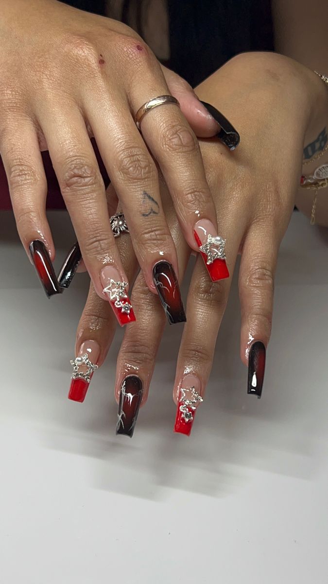 Bold Red and Black Nail Design with Metallic Accents for a Glamorous Edge.