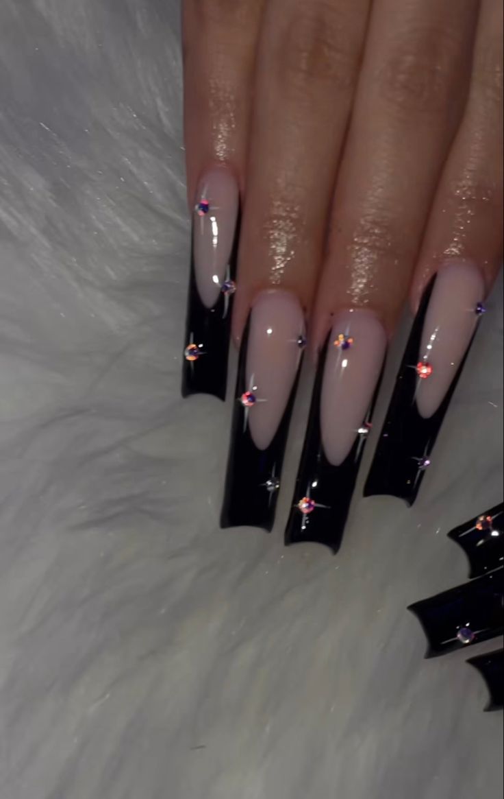 Chic Long Nails: Glossy Black and Soft Nude with Sparkling Rhinestones for a Luxurious Statement.