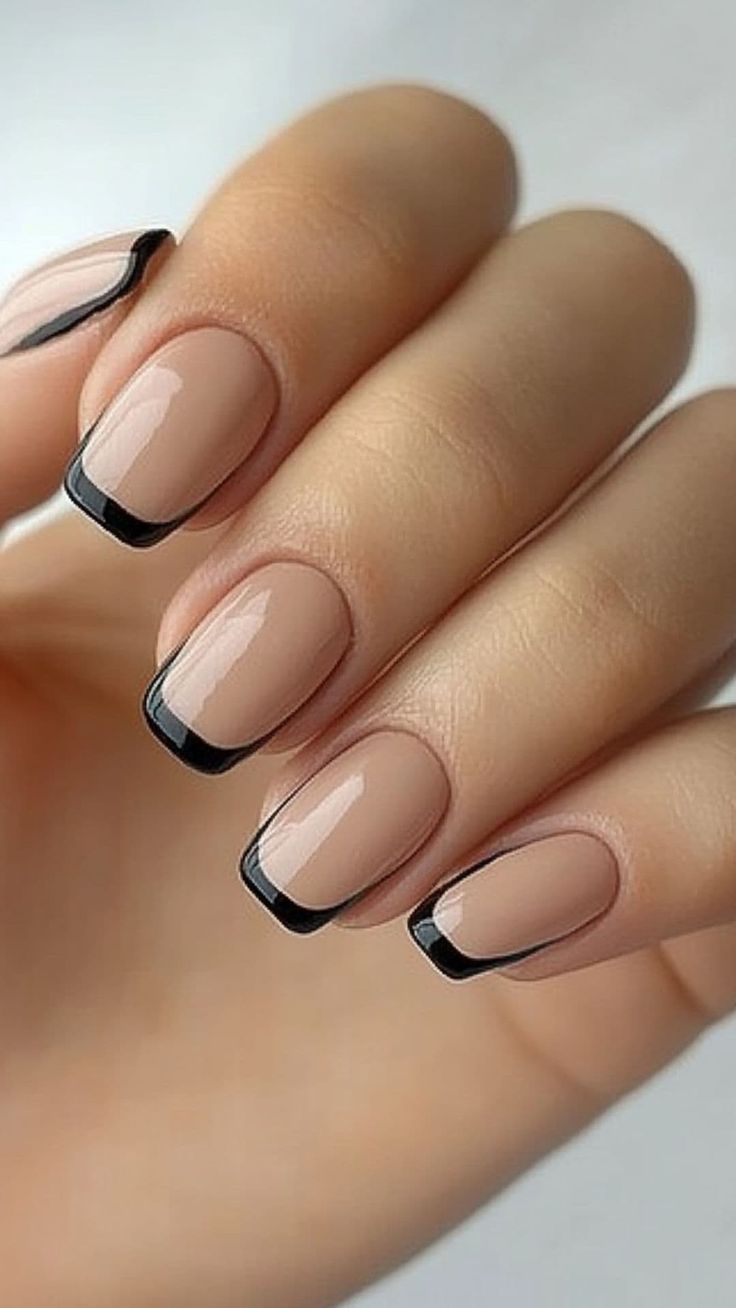 Chic Nude Base with Bold Black Tips: Elegant Nail Design for Any Occasion.