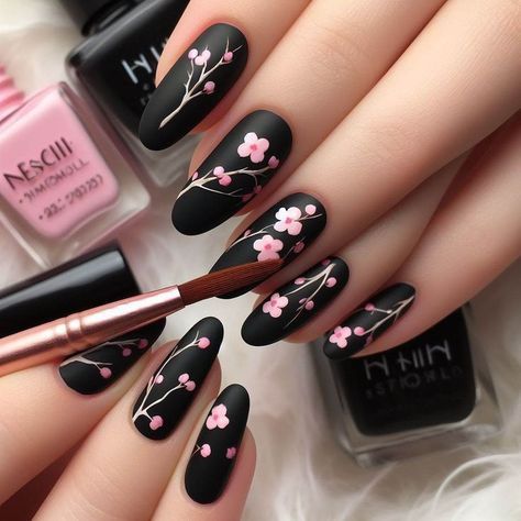 Elegant Floral Nail Art: Matte Black Base with Delicate Pink Blossoms and White Branches.