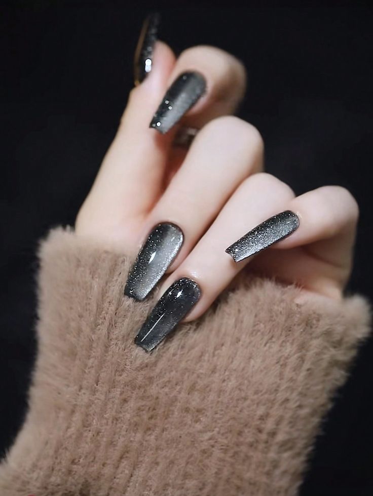 Chic Black and Silver Ombre Nails: A Striking Contrast to Cozy Textures.