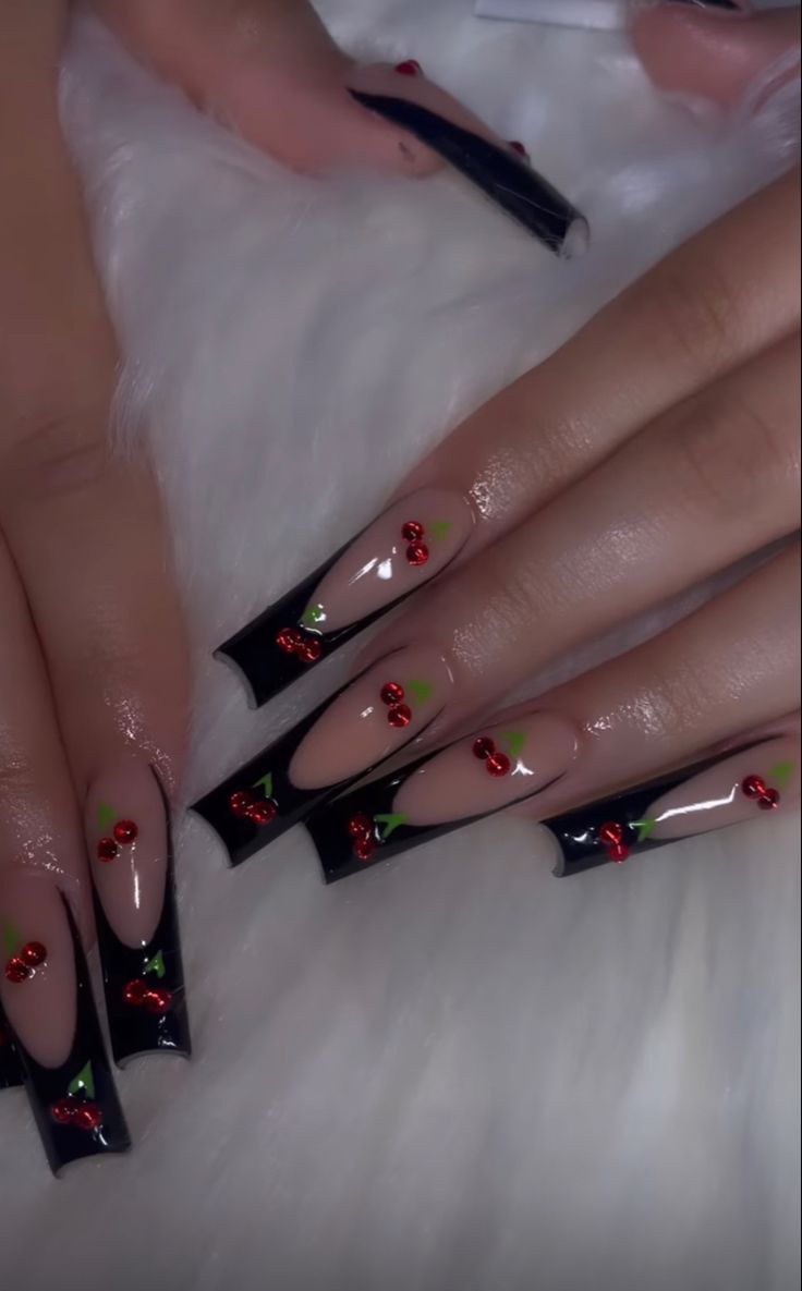 Bold Black and Nude Nail Design with Playful Cherry Motifs for a Whimsical Touch.