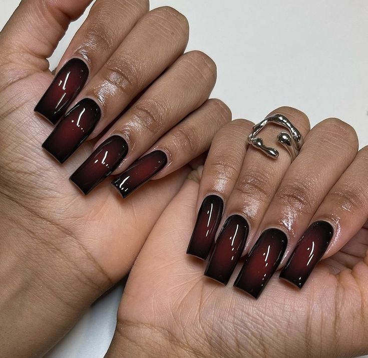 Elegant Ombre Nail Design: Deep Burgundy to Black with Glossy Finish.