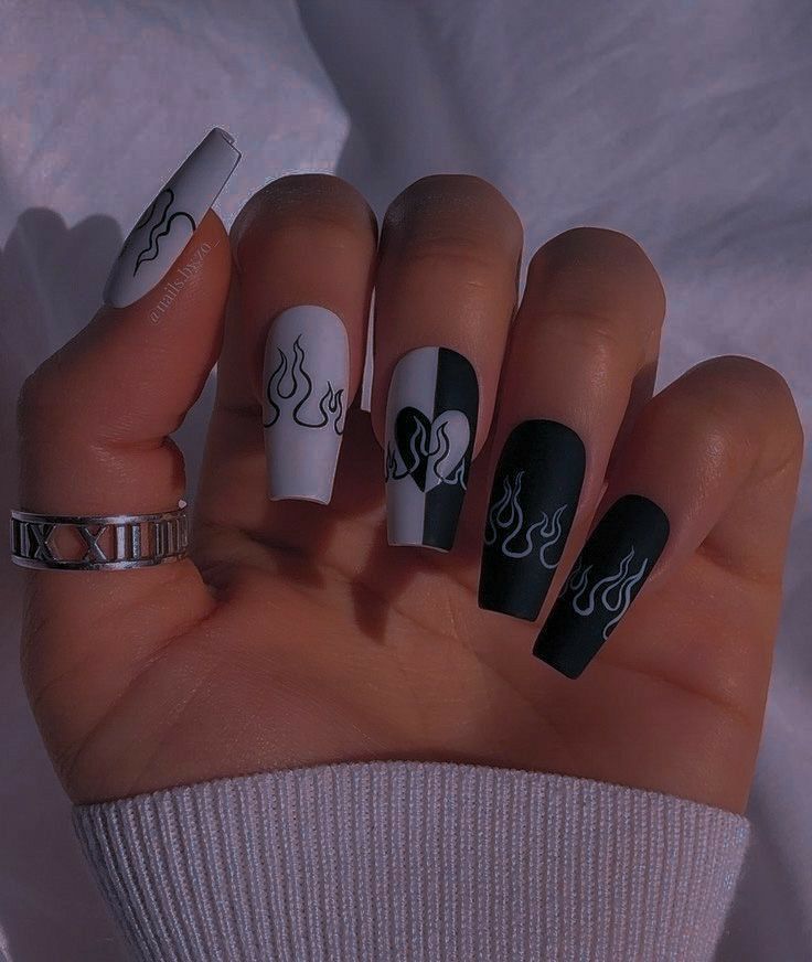 Bold Flame Nail Design: Striking Matte Black and White with Edgy Asymmetrical Layout.