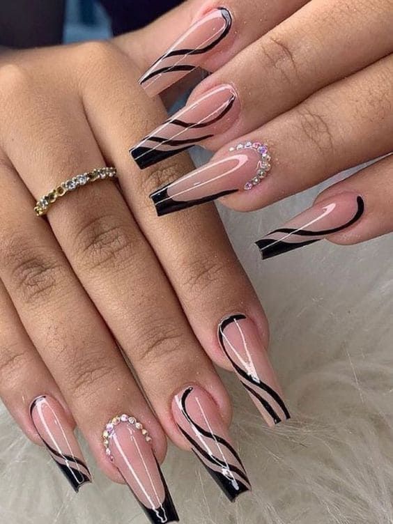 Sophisticated Nude and Glossy Black Nail Design with Delicate Stripes and Rhinestones.