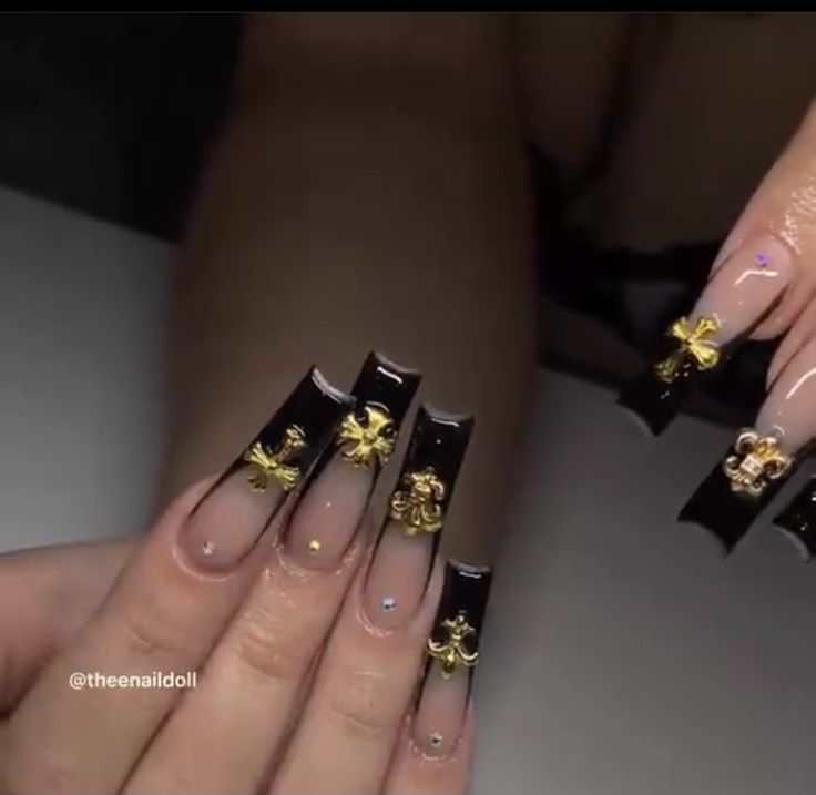 Luxurious Nail Design: Glittering Black Tips with Gold Floral and Geometric Accents.