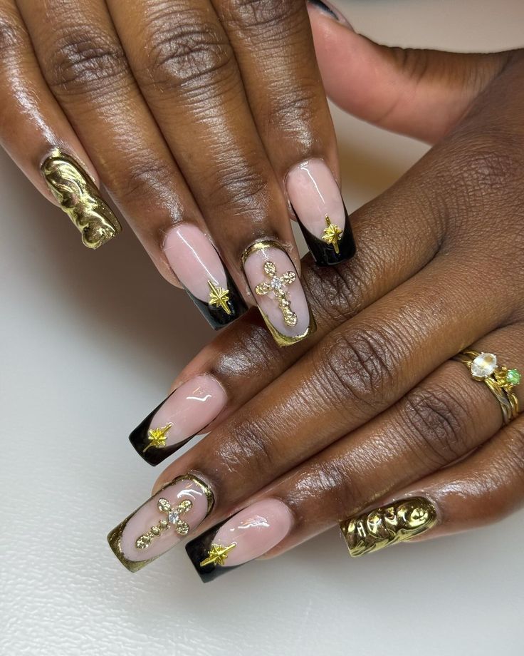 Chic Nude, Black, and Gold Nail Design with Sophisticated Embellishments and French Tips.