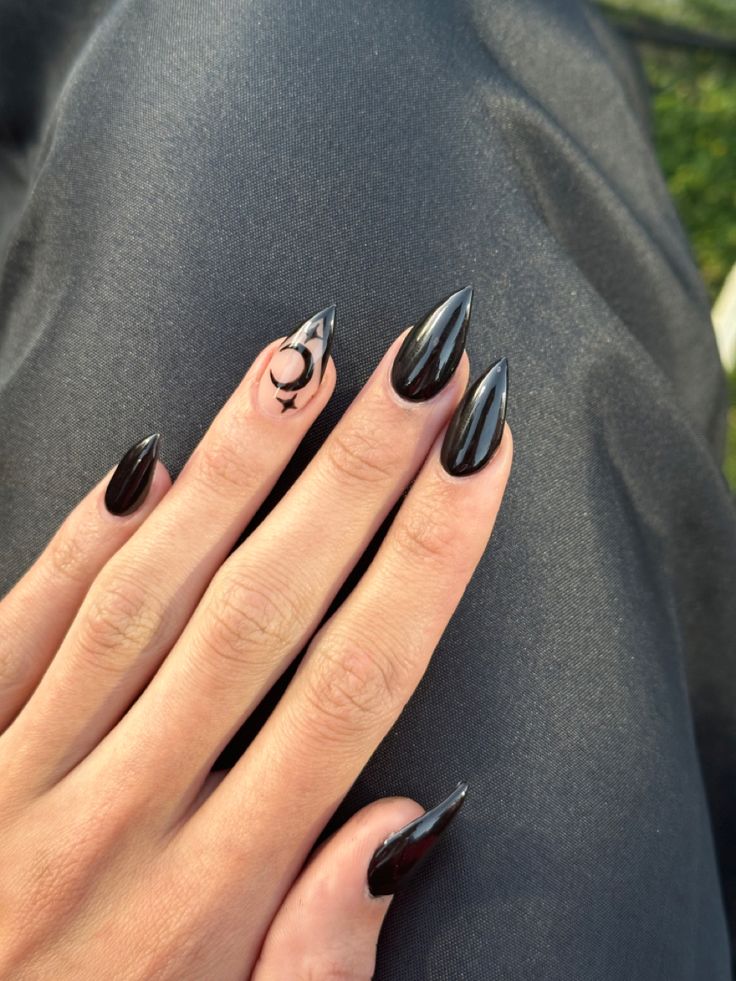 Elegant Black Stiletto Nails with Shiny Finish and Minimalist Crescent Moon Accent.