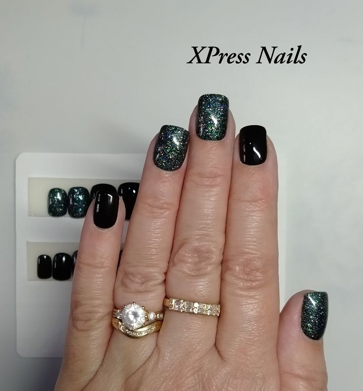 Elegant Black and Teal Nail Design with Glitter and Dainty Rings