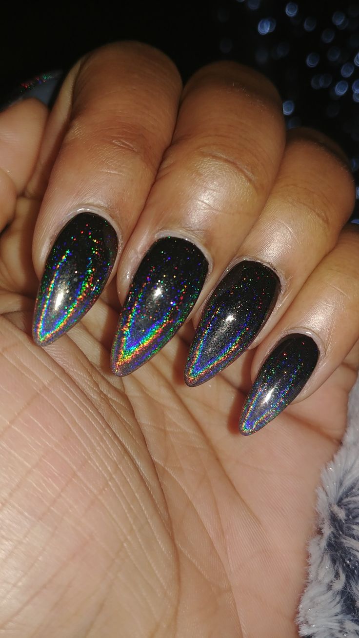 Iridescent Holographic Nail Design with Elegant Almond Tips on a Deep Black Base.