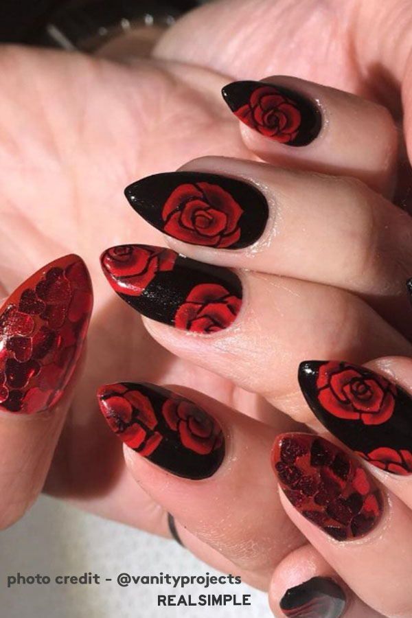 Bold Black and Red Nail Design with Intricate Rose Motifs and Textured Detailing.