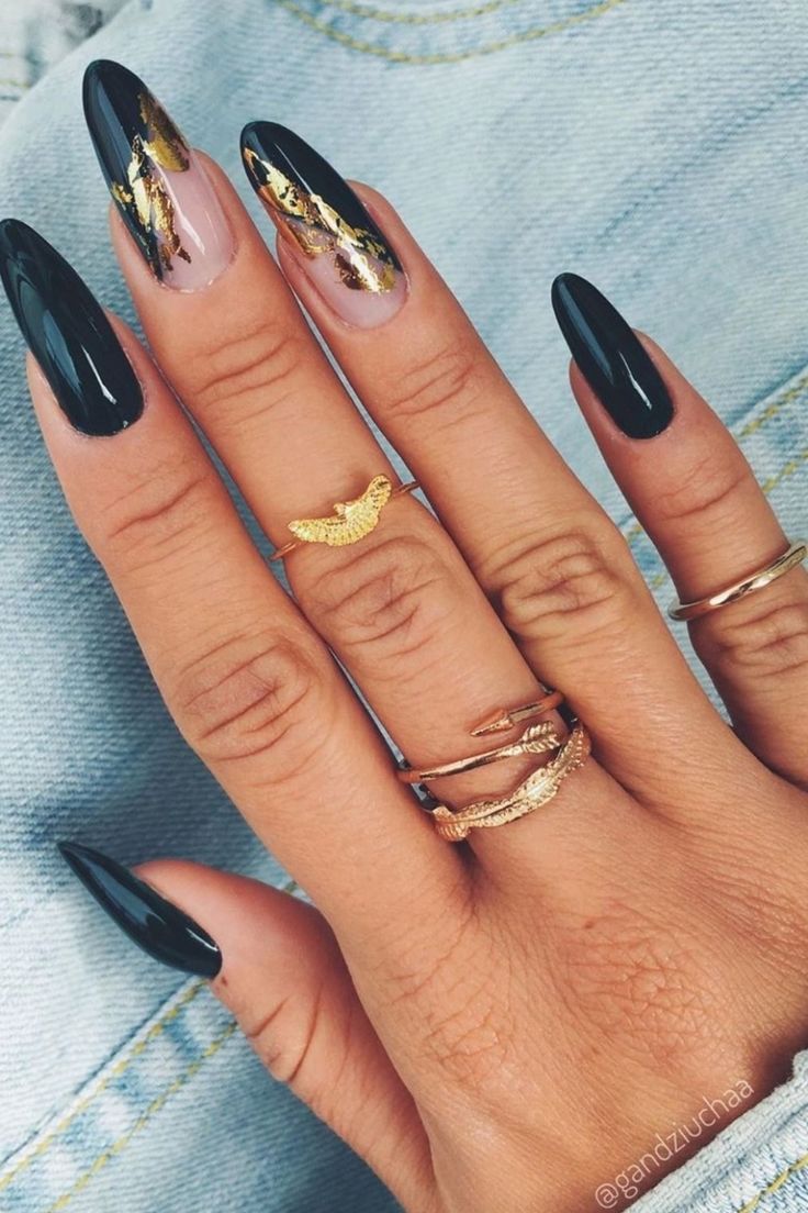 Chic Long Black Nails with Metallic Gold Accents for a Striking Statement.