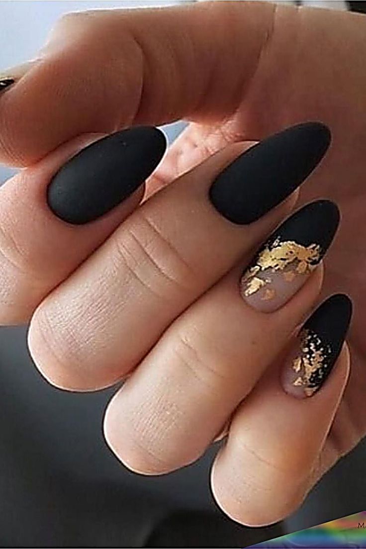 Elegant Matte Black and Gold Almond-Shaped Nail Design: A Chic Blend of Modern Glam.