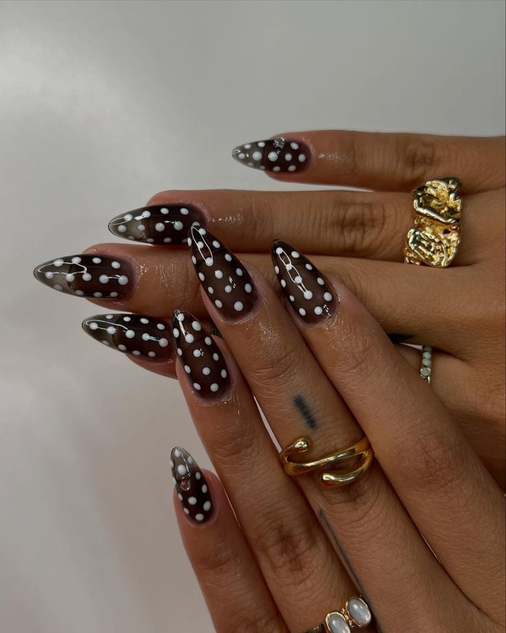 Chic Almond-Shaped Nails with Polka Dots and Statement Rings.