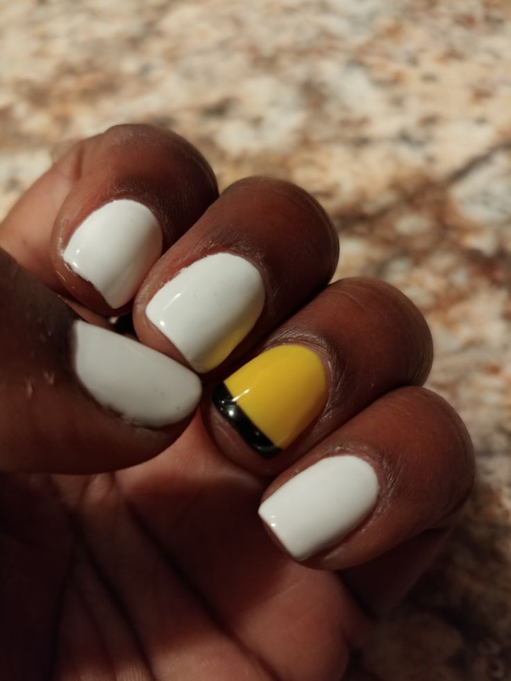 Chic Nail Design: Vibrant Yellow with Bold Black Accent.