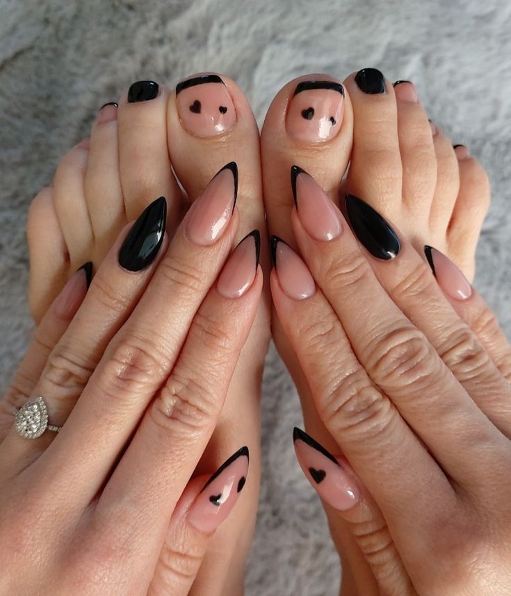 Chic Nude and Black Nail Design with Playful Heart Accents