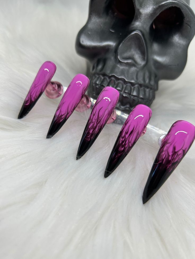 Dramatic Ombre Stiletto Nails: Vibrant Pink Meets Deep Black for an Edgy Statement Look.