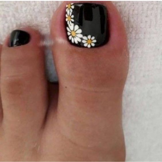 Chic Black Pedicure Design with Elegant Daisy Accents for Summer Style.