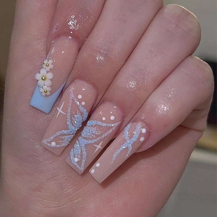 Delicate Butterfly Motif Nail Design in Soft Blue with Charming Floral Accents.