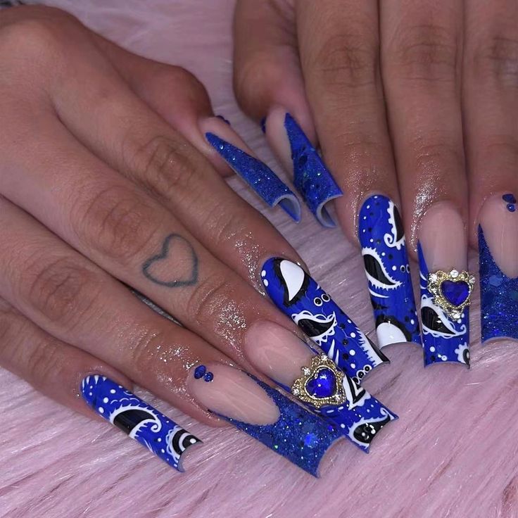 Stunning Bold Nail Design with Blue Hues and Glamorous Heart-Shaped Accents