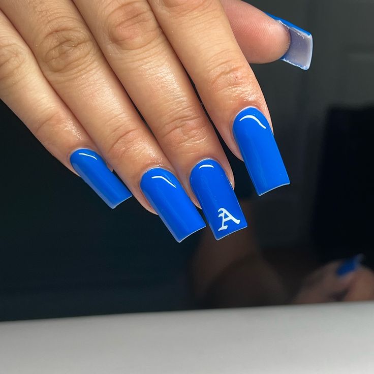 Bold Blue Glossy Square Nails with Chic White Accents.