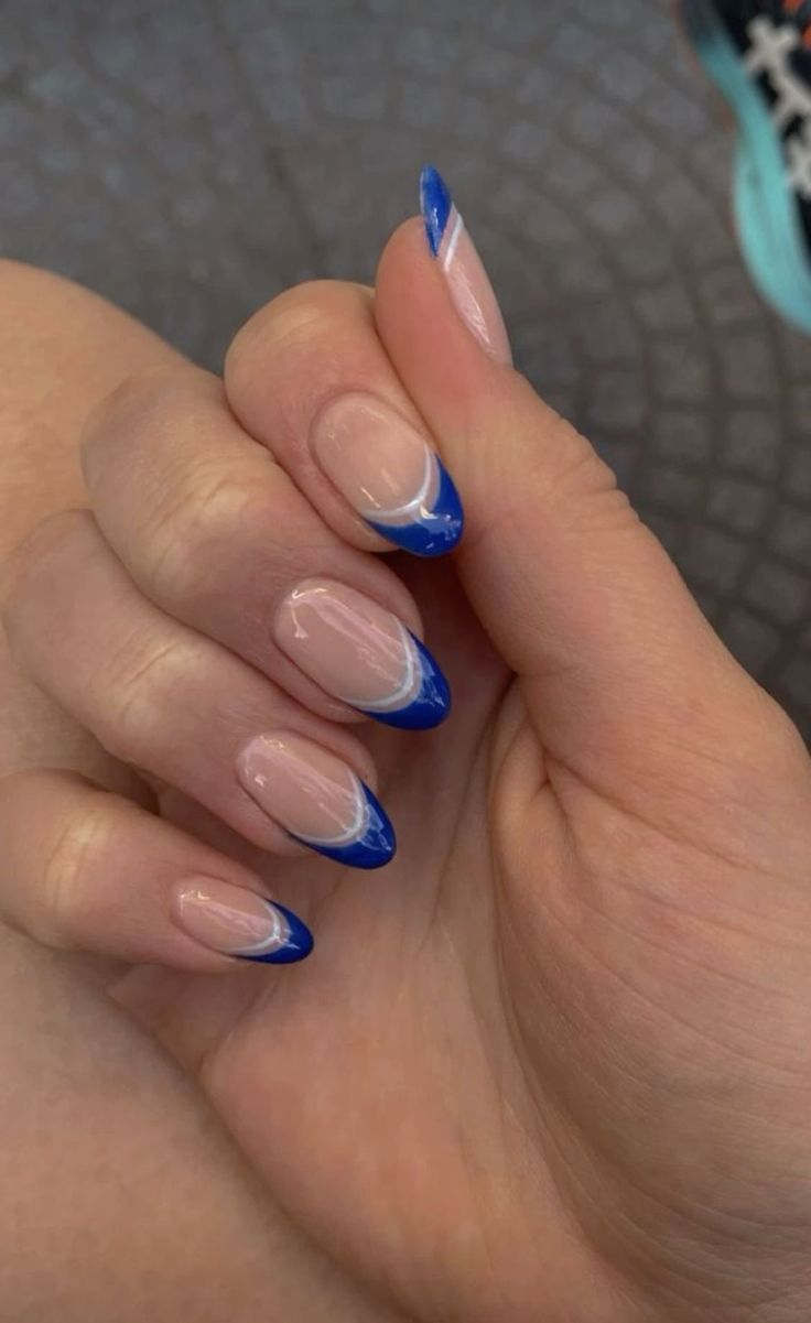 Chic Modern French Manicure with Vibrant Blue Tips and Sophisticated White Accents.