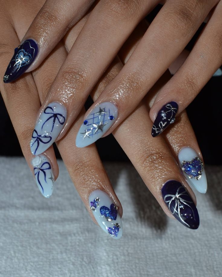 Sophisticated Blue and Deep Purple Nail Design with Elegant Bows and Shimmering Embellishments.