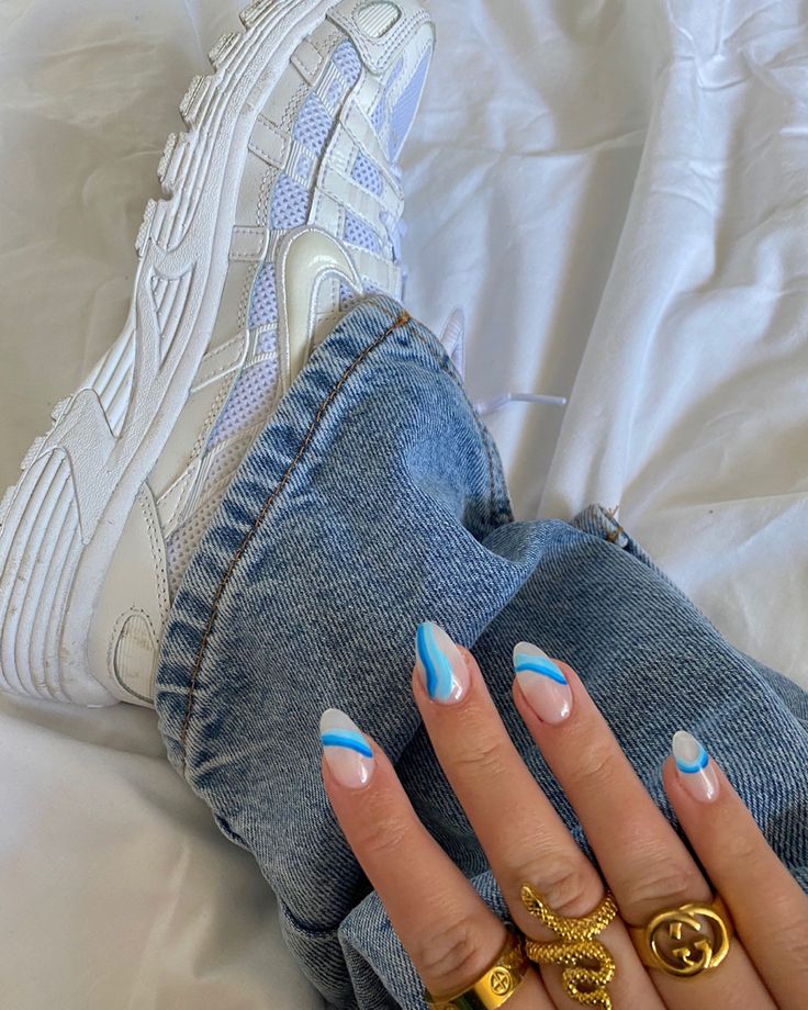 Chic Nail Design with Soft White and Vibrant Blue Accents Paired with Casual Denim and Sneakers.