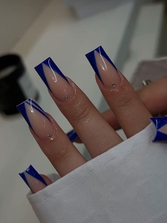 Modern Nail Design: Nude and Bold Blue Geometric Elegance with Glossy Finish