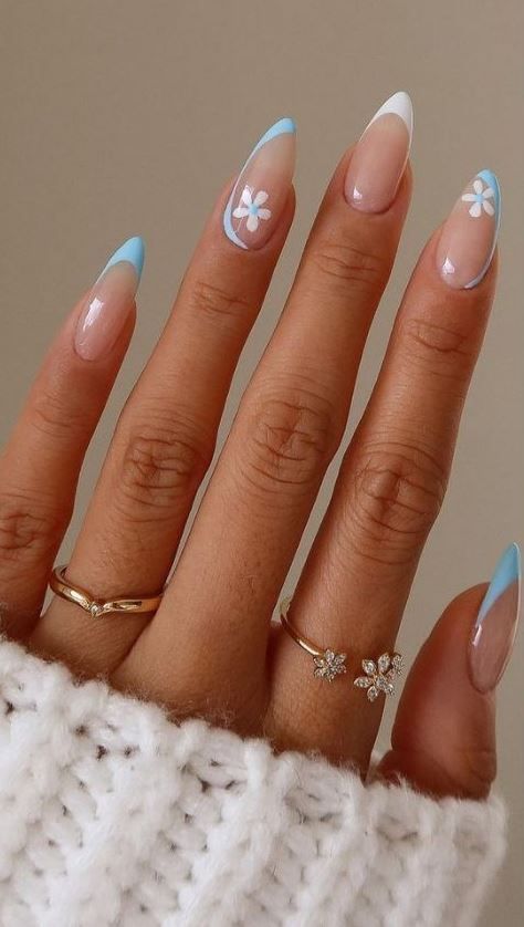 Sophisticated Pastel Almond Nails with Floral Accents and Dainty Ring Pairing