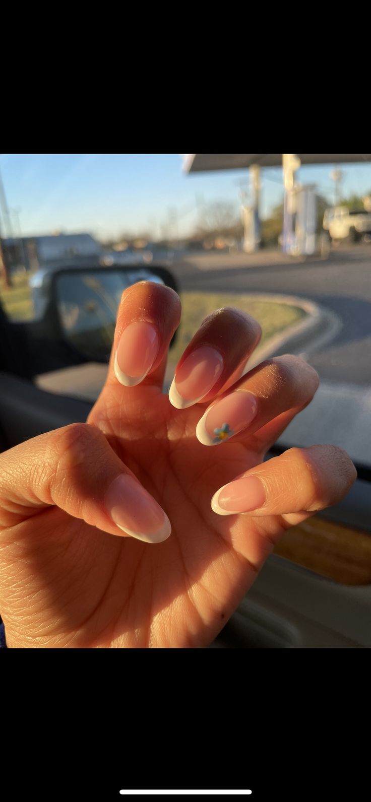 Elegant Almond-Shaped Nails with Soft Pink Base, Classic French Tips, and Delicate Floral Accents.