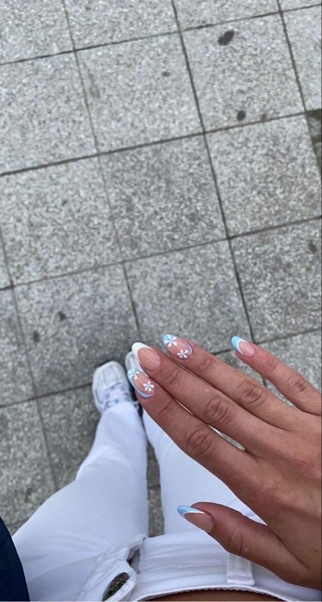 Whimsical Light Pink Nail Design with White Tips and Soft Blue Accents.