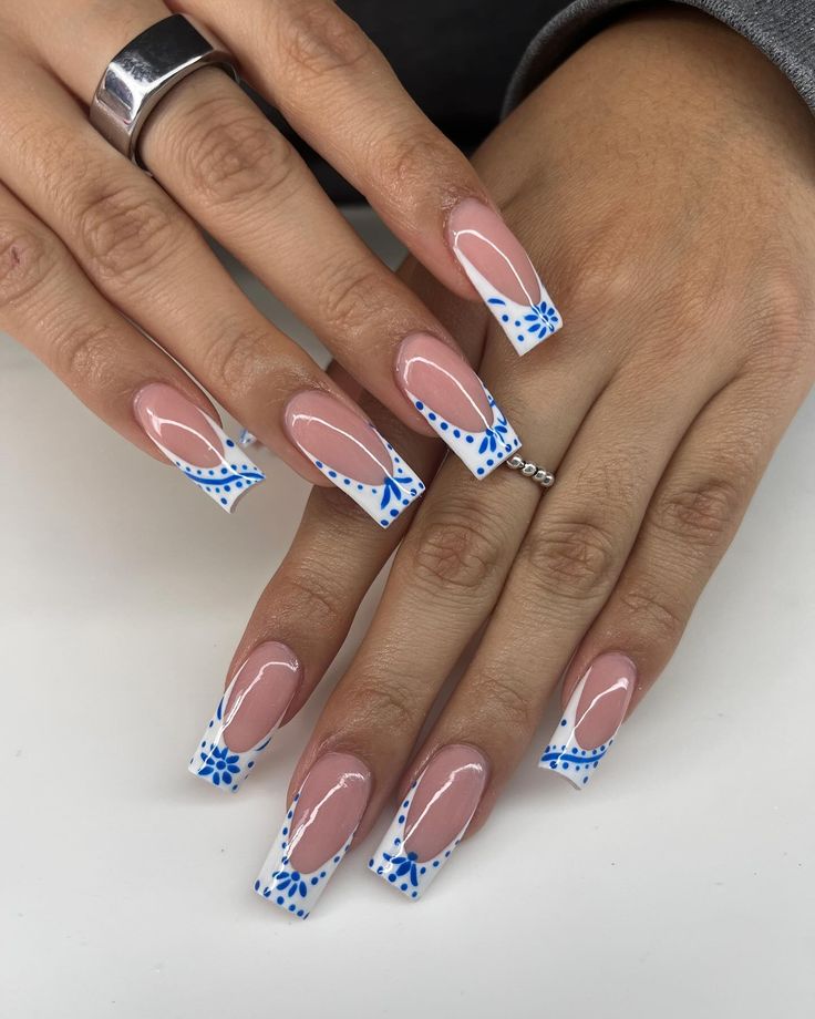 Sophisticated Long Square Nails with Nude and White Tips and Intricate Blue Floral Patterns.