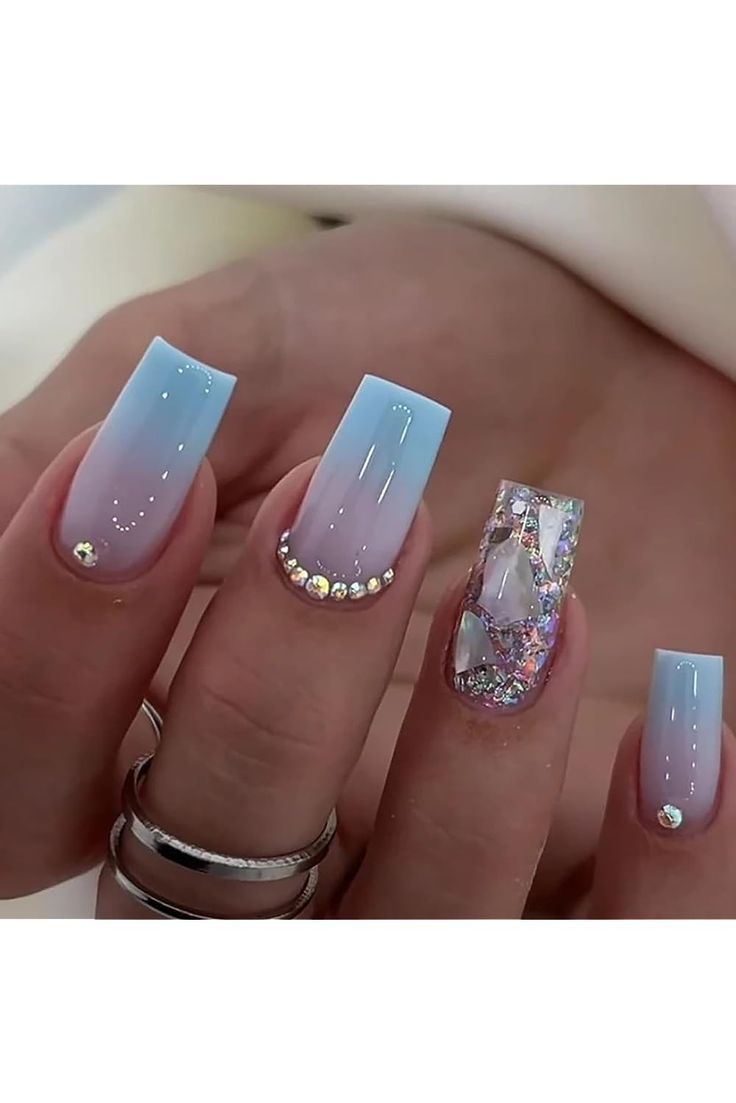 Serene Ombre Nail Design with Blue Gradients, Glamorous Rhinestones, and Playful Accent Shard Nail.