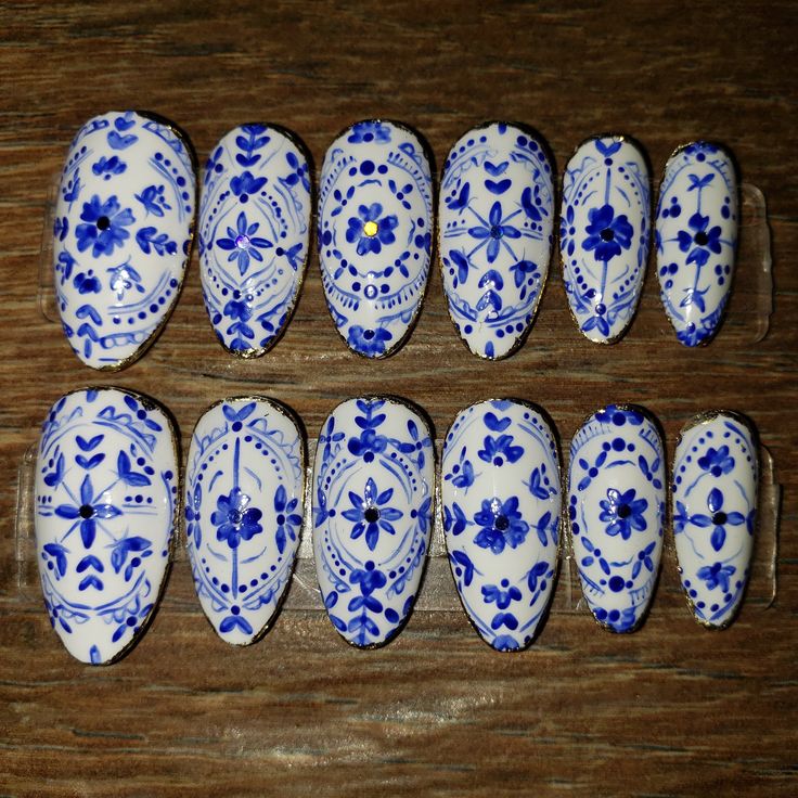 Elegant Intricate Blue Floral Nail Designs on Crisp White Background