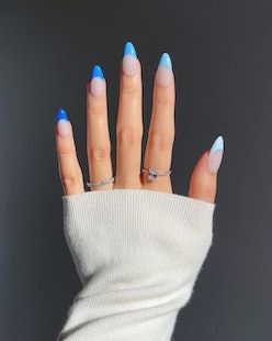 Chic Almond-Shaped Gradient Nails in Soft Blue and Nude, Accented with Delicate Rings.